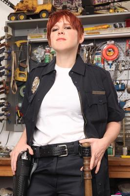 21P Short-haired police officer Lily Cade strips off her uniform and lingerie