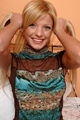 15P Young blonde cups her big natural tits while stripping to her panties