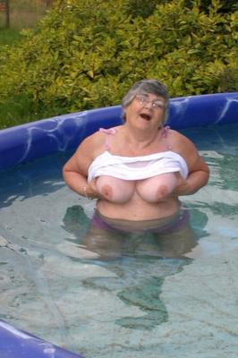 20P Overweight UK nan Grandma Libby exposes her boobs in a backyard swimming pool