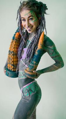 16P Heavily tattooed girl Anuskatzz holds a couple of taintacle toys in the nude