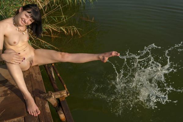 16P Dark haired teen Black Mo steps out of her bikini to pose nude on a dock