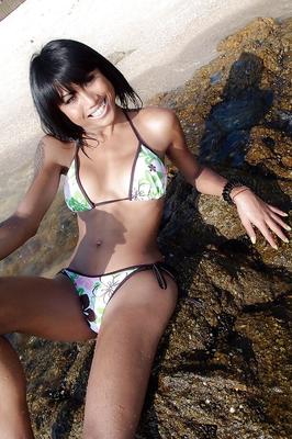 16P Beautiful Thai shemale Noon posing on a beach before sucking a hard dick
