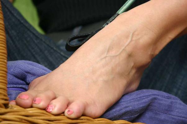 16P Barefoot mistress smokes a cig while playing with her crop whip in front of