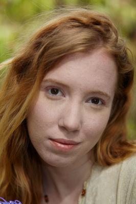 15P Natural redhead Nicki Blue shows some leg while wading into a shallow stream