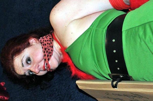 16P Busty redhead is restrained and gagged in Christmas outfits