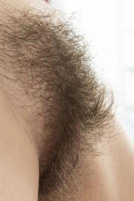 18P Busty brunette Anissa tugs her hairy pussy locks to spread her meaty lips open