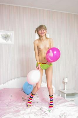 16P Sweet teen Cindy B gets naked on her bed in multi-coloured socks