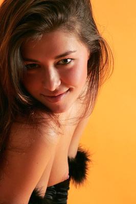 12P Young brunette wields a boa while posing nude in black velvet gloves