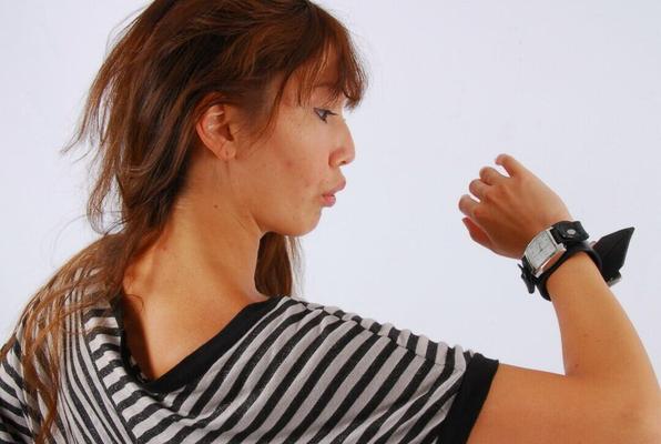 16P Asian redhead Evita glances at her huge Frilis watch while fully clothed