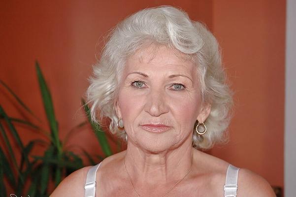 16P Lustful granny in white stockings masturbating her twat with a big dildo