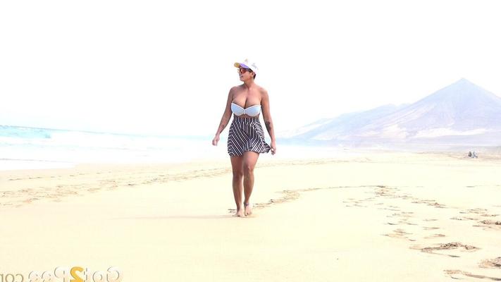 15P Caucasian female Chloe takes a piss while while traipsing on a deserted beach