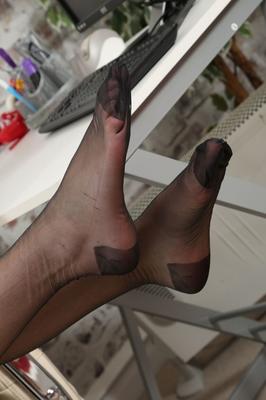 21P Ginger Celeste dangles her shoe and poses in black stockings at the office
