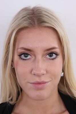 20P Blonde amateur Klara stands fully clothed and then totally naked afore a wall