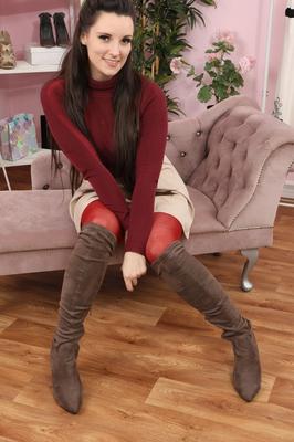 16P Brunette chick Ivy Rain goes topless before slipping red hose over her ass