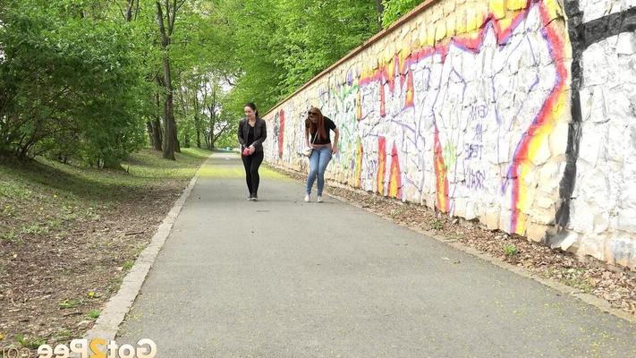 15P Two girls pull down their pants in order to piss on the road