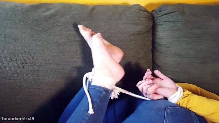 16P Caucasian female wiggles her toes while hogtied with her clothes on