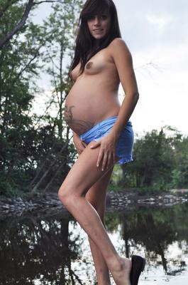 16P Brunette girl Brianna shows her tattooed belly while heavily pregnant