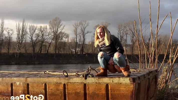 15P Pretty blonde squatting to pee by the river