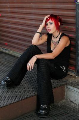15P Hot Goth girl Scarlet Starr uncups her nice tits as she strips to black boots