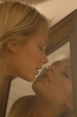 12P Blonde model Natasha Marley goes topless while fixing her lips in a mirror