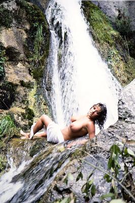 16P Solo girl Stacy Owen displays her huge breasts in front of a waterfall