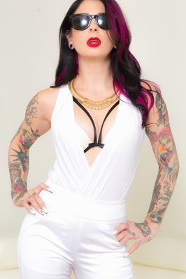 15P Inked female Joanna Angel takes off sunglasses and clothes to pose nude