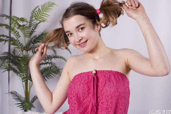 20P Cute young girl Angelica tugs on her pigtails before getting bare naked