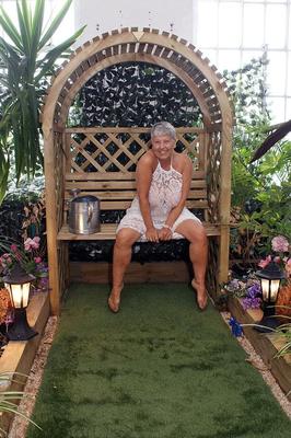20P Hot granny Savana uncorks her giant breasts while attending to garden