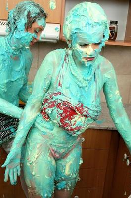 16P Clothed women cover each other in cake mix during a food fight in kitchen