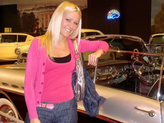17P Hungarian blonde MILF Sophie Moone posing fully dressed in front of cars