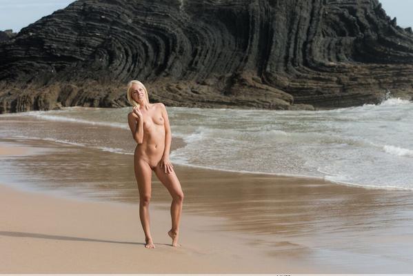 16P Slender blonde teen Tracy A strolls a deserted beach while totally naked