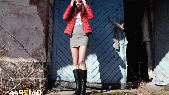 15P Brunette chick Katya squats for a piss behind a building in black boots