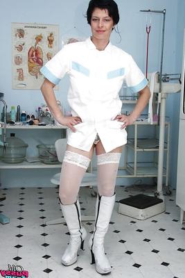 16P Seductive mature nurse in white stockings playing with a huge dildo