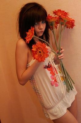 15P Charming teen Kaira 18 holds a bunch of flowers during a non nude shoot