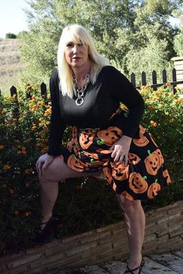 16P Mature blonde Melody exposes her bra and panties while dressed for Halloween