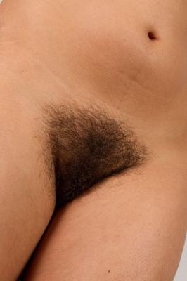 20P Hairy ebony Erica smiles as she fingers her bushy coochie on the sofa