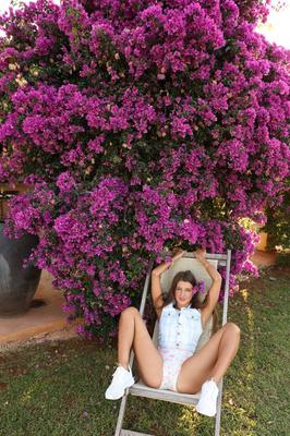 21P Sweet teen with a flower in her hair Maria stretches her vagina outdoors