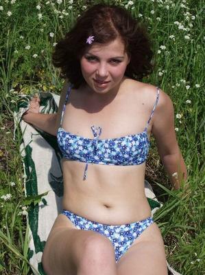 10P Young looking girl takes off her bikini to go naked amid wildflowers