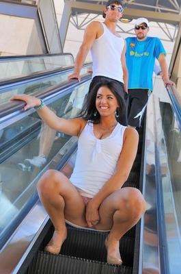 15P Super slut raises skirt to flash her ass and twat on public escalator