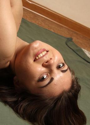 16P Topless girl lies on her back while her wrists and ankles are tied above her