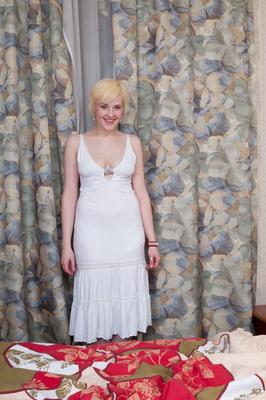17P Busty blonde chick Kira takes off her sexy white dress and shows bushy snatch