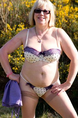 16P Blonde granny gets naked in sunglasses and stockings in a backyard