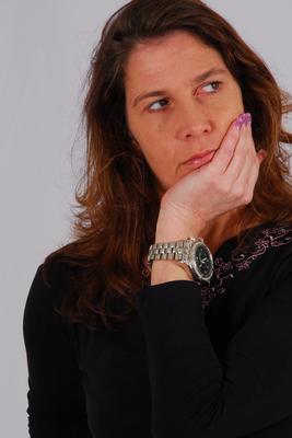 16P Caucasian model Felicia takes a glance at her huge metal watch while dressed