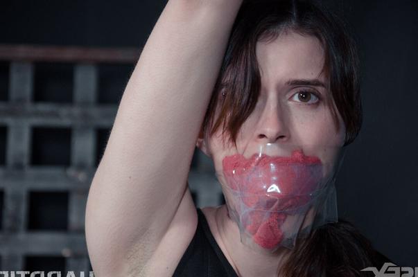 14P Naked female Sosha Belle is gagged and suspended by ropes in a dungeon