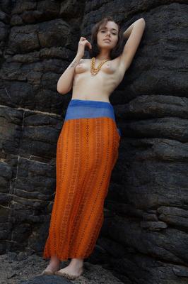 18P Young brunette Keira Blue models completely naked against a rock face