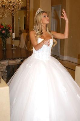 17P Stunning blonde Kendall Brooks in a wedding dress strips and poses on a couch