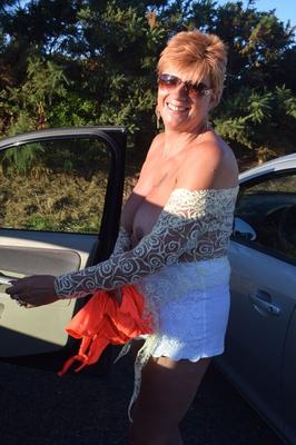 20P Mature woman with red hair lets her saggy tits free overlooking the ocean