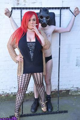 15P Mistress Jemstone hits guy in a gasmask then chains his cock