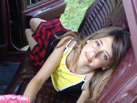 10P Young white girl shows her underboobs on the backseat of an old car in a skirt