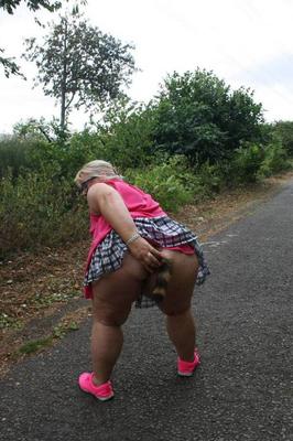 20P Fat UKwoman Lexie Cummings walks a path sporting a raccoon tail butt plug